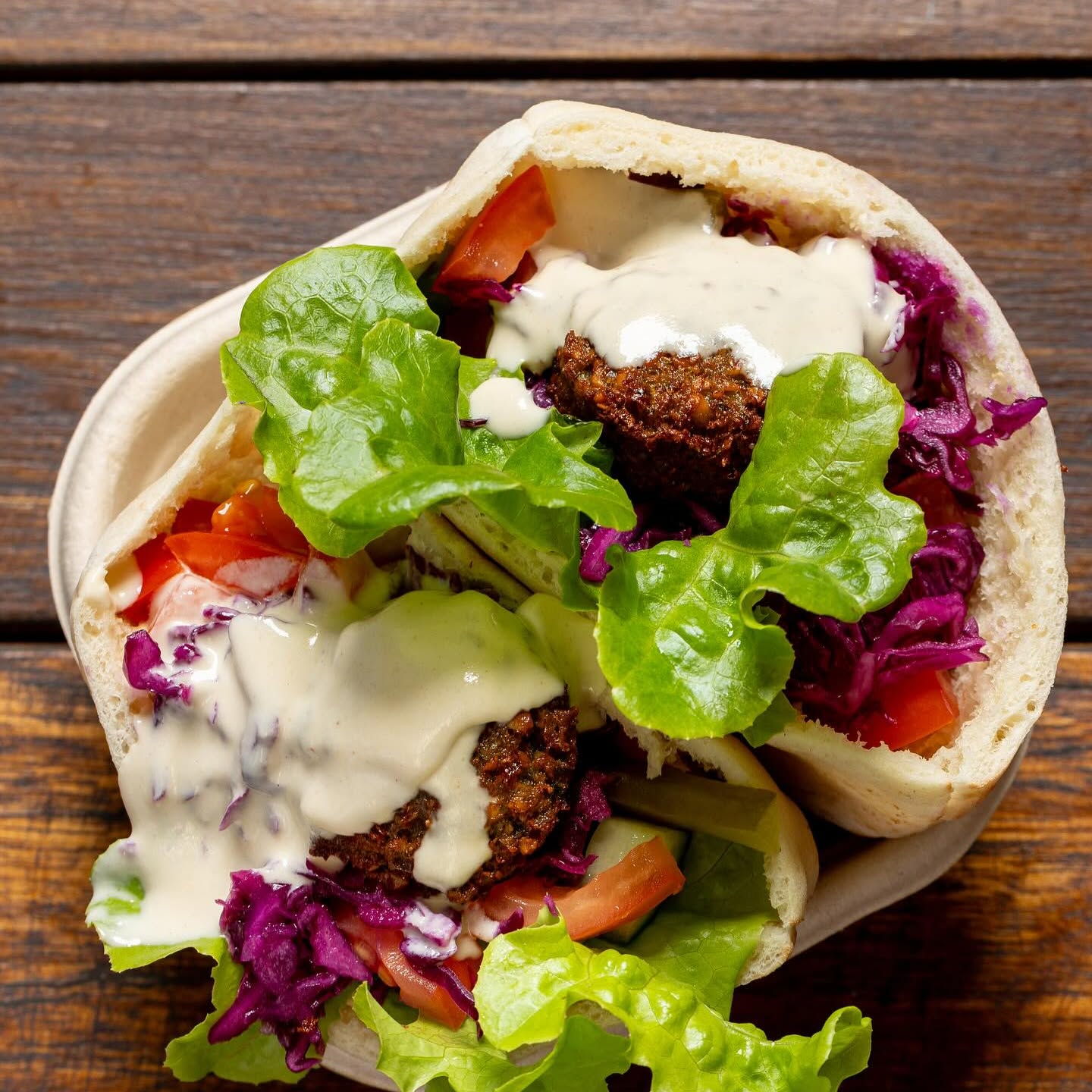 Falafel pocket with tahini, lettuce, tomato and red cabbage